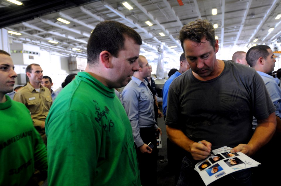 US Navy 090713-N-2344B-111 Actor D.B. Sweeney signs autographs for Sailors in the hangar bay of the aircraft carrier USS Ronald Reagan (CVN 76)