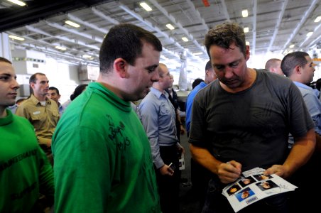 US Navy 090713-N-2344B-111 Actor D.B. Sweeney signs autographs for Sailors in the hangar bay of the aircraft carrier USS Ronald Reagan (CVN 76) photo