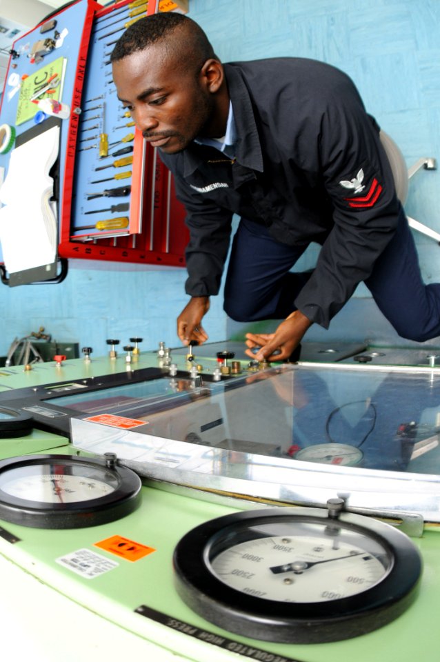 US Navy 090715-N-5821P-003 ircrew Survival Equipmentman 2nd Class Kwesi Etsiwamensah, from Greensboro, N.C. assigned to the aircraft intermediate maintenance department at Naval Air Station Sigonella, performs a bench test on a