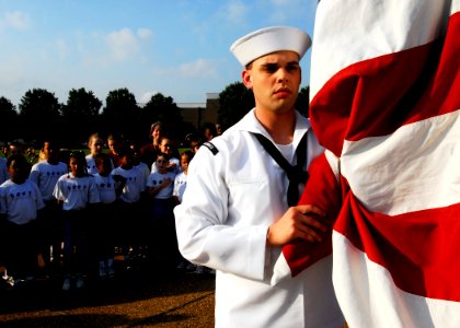 US Navy 090714-N-2456S-023 Information Systems Technician 3rd Class Jacob Hirsch, assigned to Commander, U.S. 2nd Fleet, prepares to raise the ensign during morning colors
