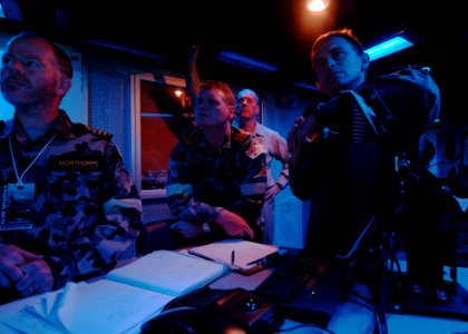 US Navy 090715-N-7282P-129 Military guests from the Australian Defense Force listen to a brief on the operations of USS George Washington (CVN 73) in the Combat Direction Center