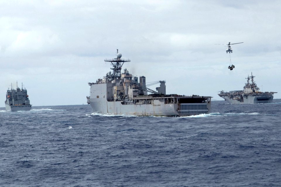 US Navy 090712-N-9123L-084 Military Sealift Command dry cargo-ammunition ship USNS Amelia Earhart (T-AKE 6) conducts vertical replenishment operations with dock landing ship USS Tortuga (LSD 46) and amphibious assault ship USS