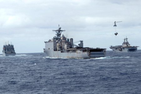 US Navy 090712-N-9123L-084 Military Sealift Command dry cargo-ammunition ship USNS Amelia Earhart (T-AKE 6) conducts vertical replenishment operations with dock landing ship USS Tortuga (LSD 46) and amphibious assault ship USS