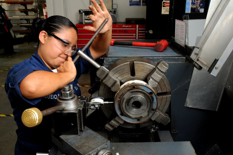 US Navy 090715-N-5821P-001 achinery Repairman Fireman Catalina Figueroa, from Milwaukee, Wis. assigned to the aircraft intermediate maintenance department at Naval Air Station Sigonella, adjusts the concentricity of a clutch pl