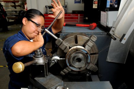 US Navy 090715-N-5821P-001 achinery Repairman Fireman Catalina Figueroa, from Milwaukee, Wis. assigned to the aircraft intermediate maintenance department at Naval Air Station Sigonella, adjusts the concentricity of a clutch pl