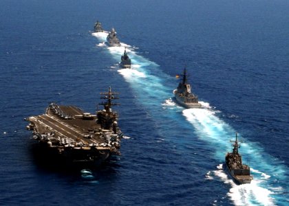 US Navy 090713-N-9988F-319 A multinational formation of ships prepares to come alongside the aircraft carrier USS Dwight D. Eisenhower (CVN 69) during a pass and review exercise