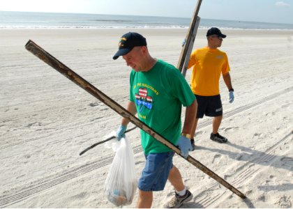 US Navy 090716-N-0486G-004 Two Sailors from the guided-missile destroyer USS The Sullivans (DDG 68), collect trash on the beachfront at Naval Station Mayport