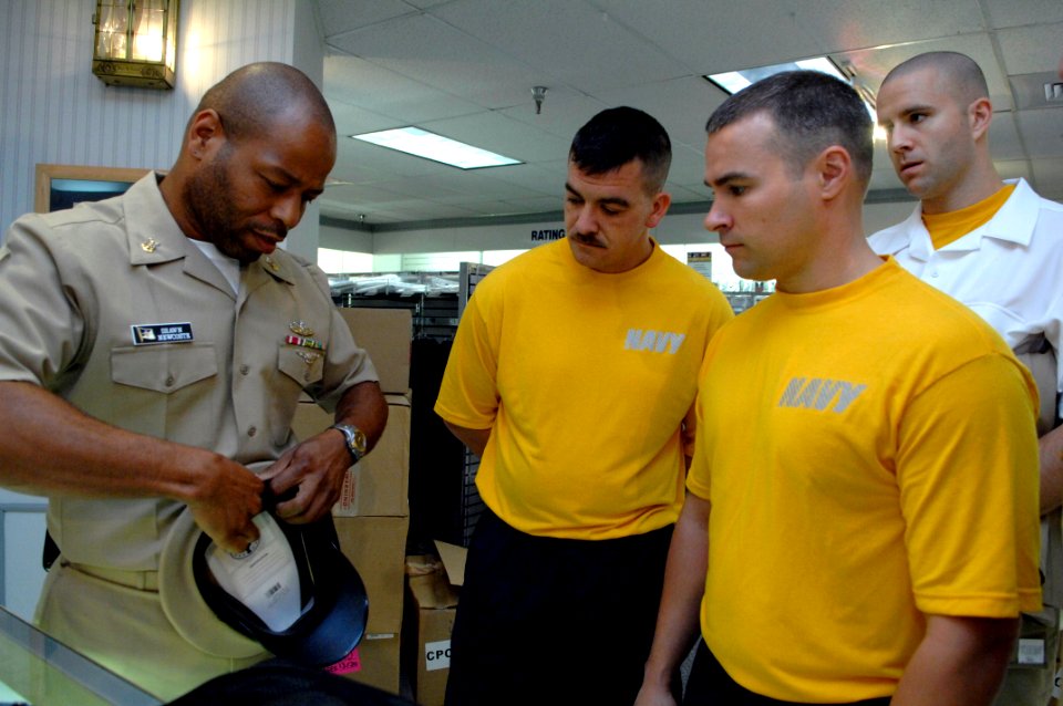 US Navy 090713-N-9818V-083 Master Chief Petty Officer Shawn Newcoste shows the 2009 Sailors of the Year how to put together a chief's combination cover