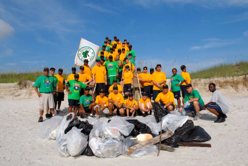 US Navy 090716-N-0486G-005 Sailors assigned to the guided-missile destroyer USS The Sullivans (DDG 68) stand behind the trash they collected during the mid-summer beachfront clean up at Naval Station Mayport