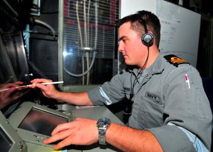 US Navy 090714-N-6233C-003 Royal Australian Navy Lt. Dale Axford gets some hands-on training in the Combat Direction Center aboard the aircraft carrier USS George Washington (CVN 73)