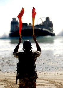 US Navy 090715-N-9520G-201 Seaman Nyja Allen, from New York assigned to Beach Master Unit (BMU) 1, directs Landing Craft Air Cushion (LCAC) 21