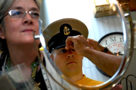 US Navy 090713-N-9818V-077 Chief Machinist's Mate Jordan Rosado helps Aviation Warfare Systems Operator 1st Class William Frost, Reserve Sailor of the Year, get fitted for his new uniform