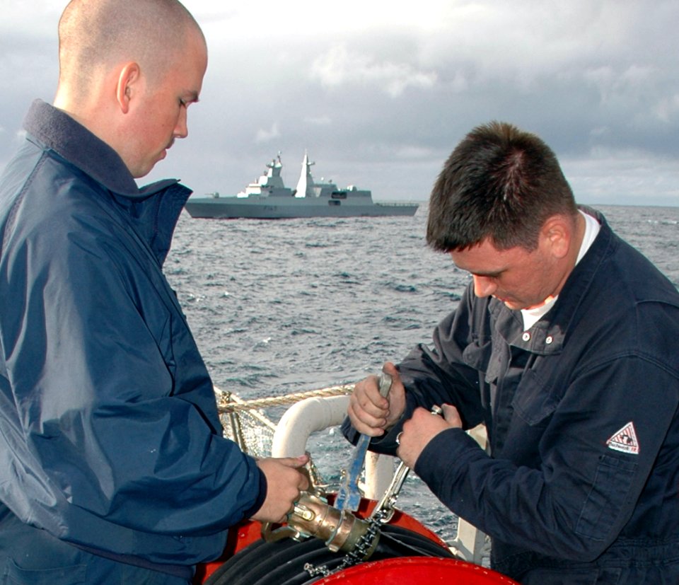 US Navy 090715-N-1655H-011 Damage Controlman Fireman Jason King, left, and Damage Controlman Fireman Dustin Collins conduct preventive maintenance aboard the guided-missile destroyer USS Arleigh Burke (DDG 51)