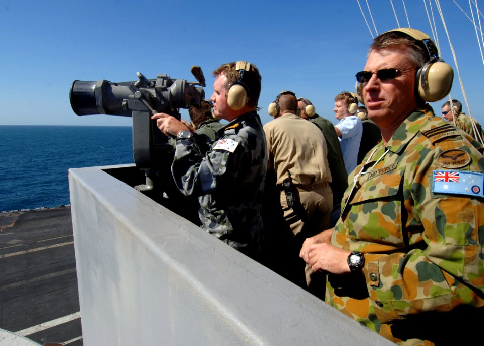 US Navy 090715-N-7282P-035 Operations Officer of Northern Command, Cmdr. Darren Grogan, left, and Logisting Engineering Officer 82nd Wing, Wing Cdr. Greg Rawlinson, right, of the Australian Defense Force, observe flight operati