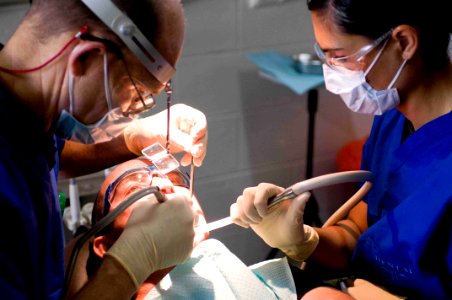 US Navy 090715-N-9689V-004 Mark Coussens and Canadian Army Cpl. Katarina Vasic provide dental treatment to a local man during a Pacific Partnership 2009 medical civic action project at Niu'ui Hospital