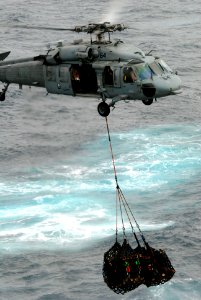 US Navy 090716-N-9132C-037 An MH-60S Sea Hawk helicopter assigned to the Blackjacks of Helicopter Sea Combat Squadron (HS) 21 transports cargo during a replenishment at sea with the aircraft carrier USS Ronald Reagan (CVN 76)