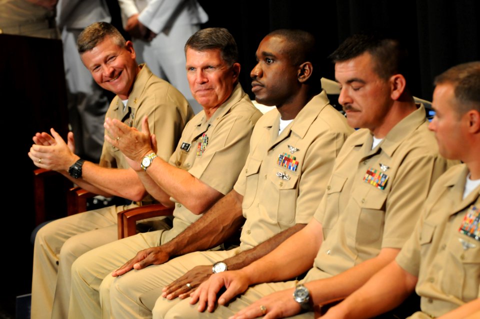 US Navy 090716-N-9818V-230 Master Chief Petty Officer of the Navy (MCPON) Rick West and Rear Adm. Robert Burt, Chief of Navy Chaplains, applauds the 2009 Sailors of the Year during a promotion ceremony at the Navy Memorial