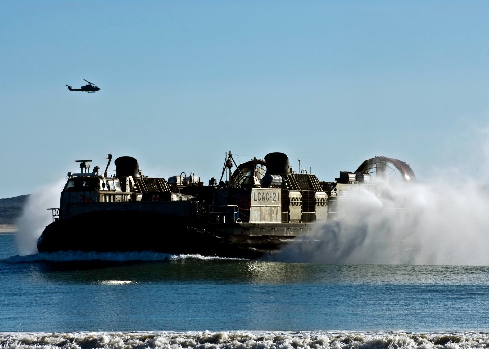 US Navy 090715-N-5253W-048 Landing Craft Air Cushion (LCAC) 21, assigned to Assault Craft Unit Five (ACU-5) Detachment Western Pacific, transports U.S. Marines and vehicles to the beach