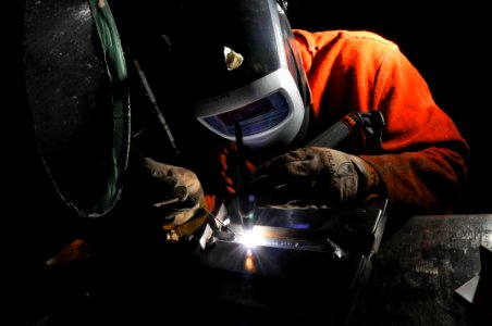 US Navy 090715-N-5821P-002 Aviation Support Equipment Technician Airman Anthony Hammond performs tungsten inert gas welding during a training evolution photo