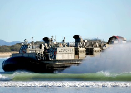 US Navy 090715-N-9520G-120 anding Craft Air Cushion (LCAC) 21, assigned to Assault Craft Unit (ACU) 5, Det. Western Pacific, returns to Freshwater Bay from the amphibious assault ship USS Essex (LHD 2) to offload Marines and eq