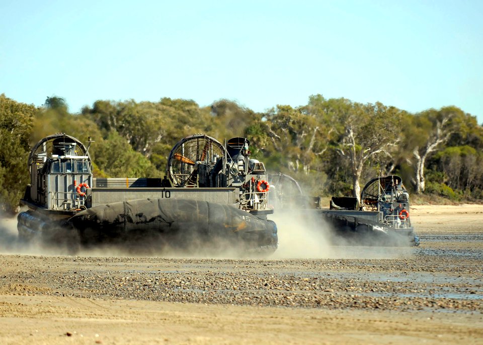 US Navy 090715-N-9520G-225 Landing Craft Air Cushion (LCAC) 10, assigned to Assault Craft Unit (ACU) 5, Det. Western Pacific, departs Freshwater Bay to return to the amphibious assault ship USS Essex (LHD 2)