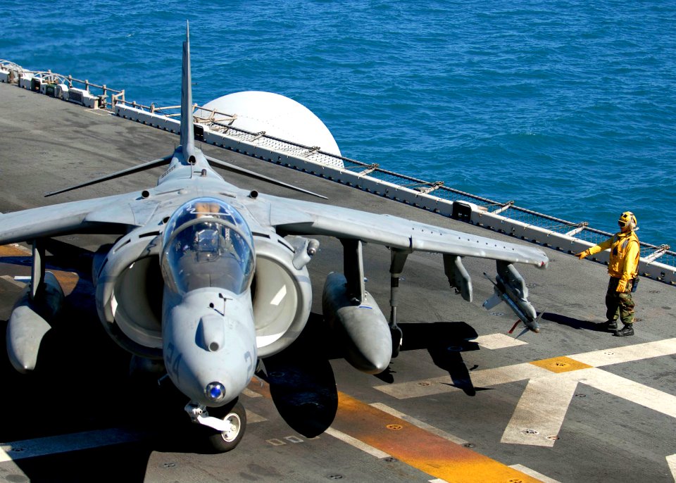 US Navy 090716-N-9950J-173 Aviation Boatswain's Mate (Handling) 2nd Class Quoc Nguyen, from Sacramento, Calif., directs a taxiing AV-8B Harrier aircraft on the flight deck of the amphibious assault ship USS Essex (LHD 2)