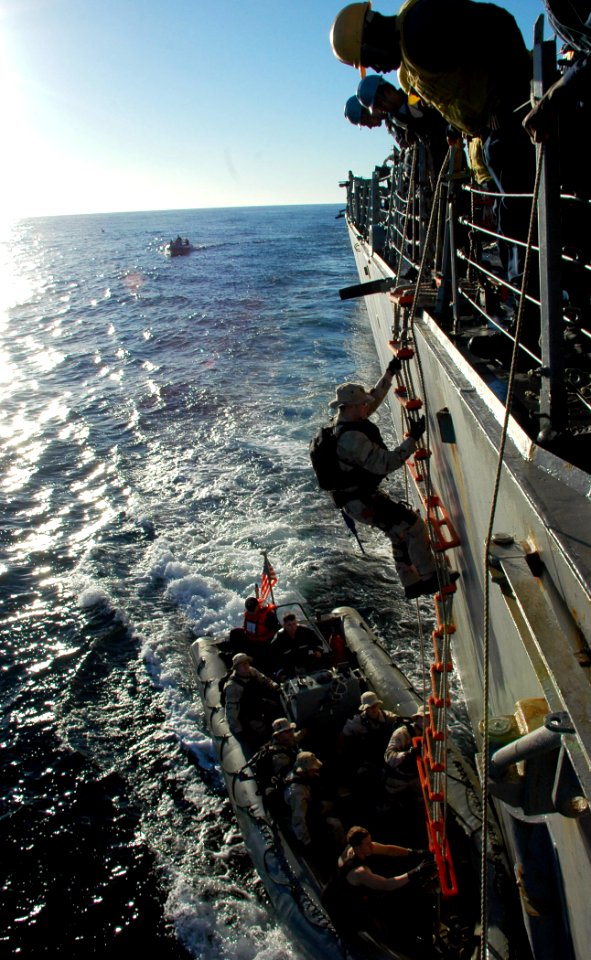 US Navy 090717-N-1655H-206 Members of the visit, board, search and seizure (VBSS) team of the guided-missile destroyer USS Arleigh Burke (DDG 51) lower a rigid hull inflatable boat into the water