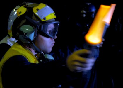 US Navy 090717-N-5538K-093 Boatswain's Mate 1st Class Louis M. Peters guides a landing craft air cushion out of the well deck of the amphibious transport dock ship USS Denver (LPD 9) during a Talisman Saber 2009 training exerci