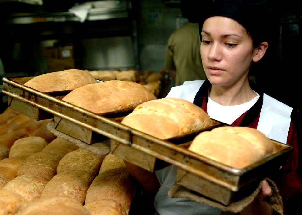 US Navy 090717-N-2013O-010 Culinary Specialist Seaman Samantha Garza carries fresh bread to a prep station aboard the aircraft carrier USS George Washington (CVN 73)