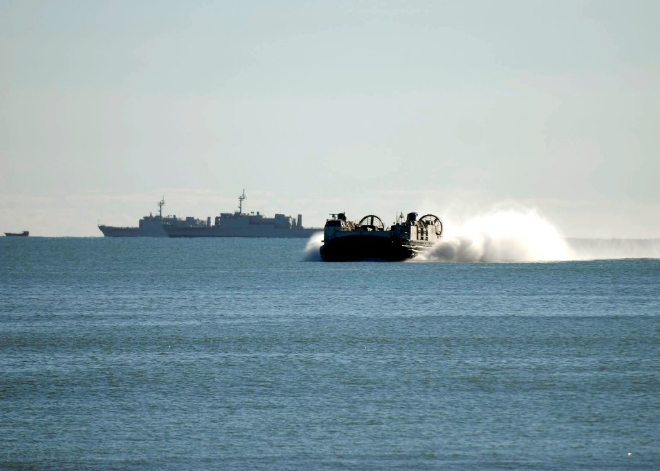 US Navy 090715-N-9520G-113 Landing Craft Air Cushion (LCAC) 21, assigned to Assault Craft Unit (ACU) 5, Det. Western Pacific, returns to Freshwater Bay from the amphibious assault ship USS Essex (LHD 2)