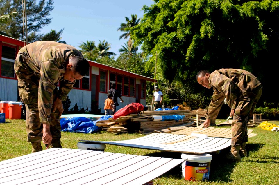 US Navy 090717-N-9689V-006 Tongan Defense Service Cpl. Paul Prescott and Lance Cpl. John Foloamoe paint during a Pacific Partnership 2009 engineering civic action project at Faeleloa Primary School