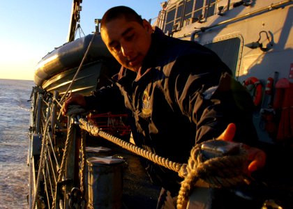 US Navy 090717-N-1655H-017 Boatswain's Mate Seaman Nelson Noriega secures a lifeline aboard the guided-missile destroyer USS Arleigh Burke (DDG 51) as the ship is underway off the coast of South Africa