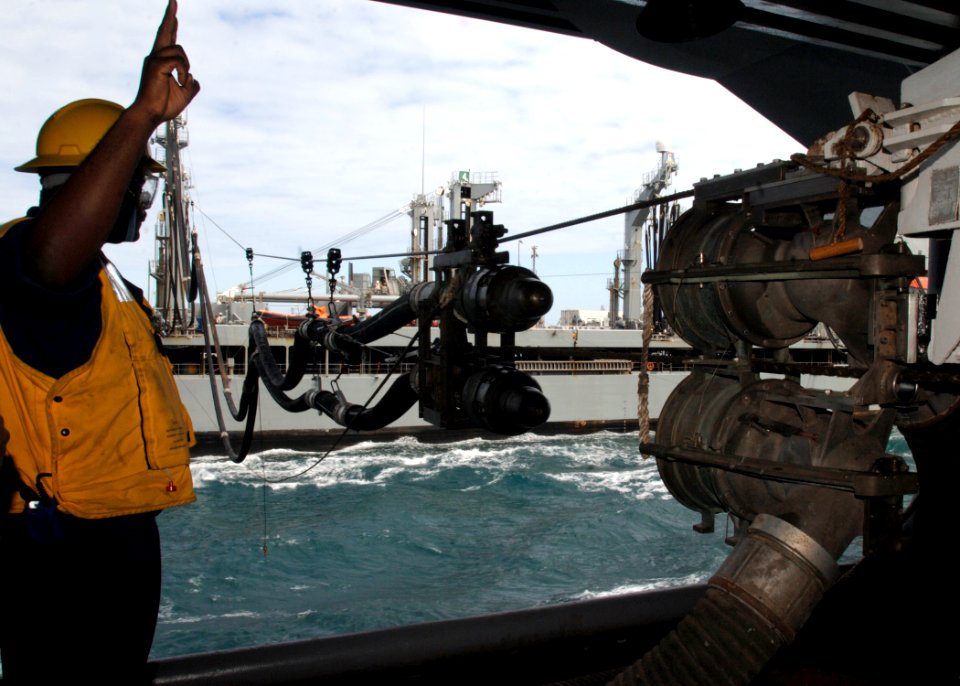 US Navy 090718-N-2013O-019 Boatswain's Mate 2nd Class Travell Young gives orders to the capstan operator aboard the aircraft carrier USS George Washington (CVN 73) during a replenishment at-sea