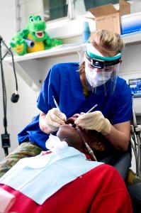 US Navy 090715-N-9689V-003 Australian Army Cpl. Diane Beningfield, dental technician, provides dental treatment to a local man during a Pacific Partnership 2009 medical civic action project at Niu'ui Hospital