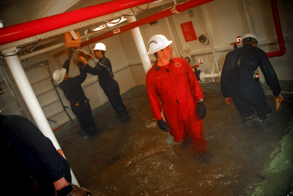US Navy 090716-N-8590G-005 Hull Technician 1st Class Christopher McGraw, a damage control instructor, monitors the damage control team of the guided-missile frigate USS John L. Hall (FFG 32) during the Damage Control Olympics