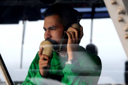 US Navy 090718-N-3610L-361 Aviation Boatswain's Mate (Equipment) 2nd Class Edward Cisneros stands watch in primary flight control (PRI-FLY) aboard the aircraft carrier USS Ronald Reagan (CVN 76)