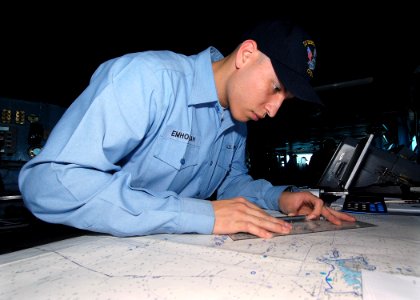 US Navy 090717-N-6720T-249 Quartermaster 3rd Class Chris Emhoolah plots the ship's course on the navigational bridge aboard the aircraft carrier USS George Washington (CVN 73)