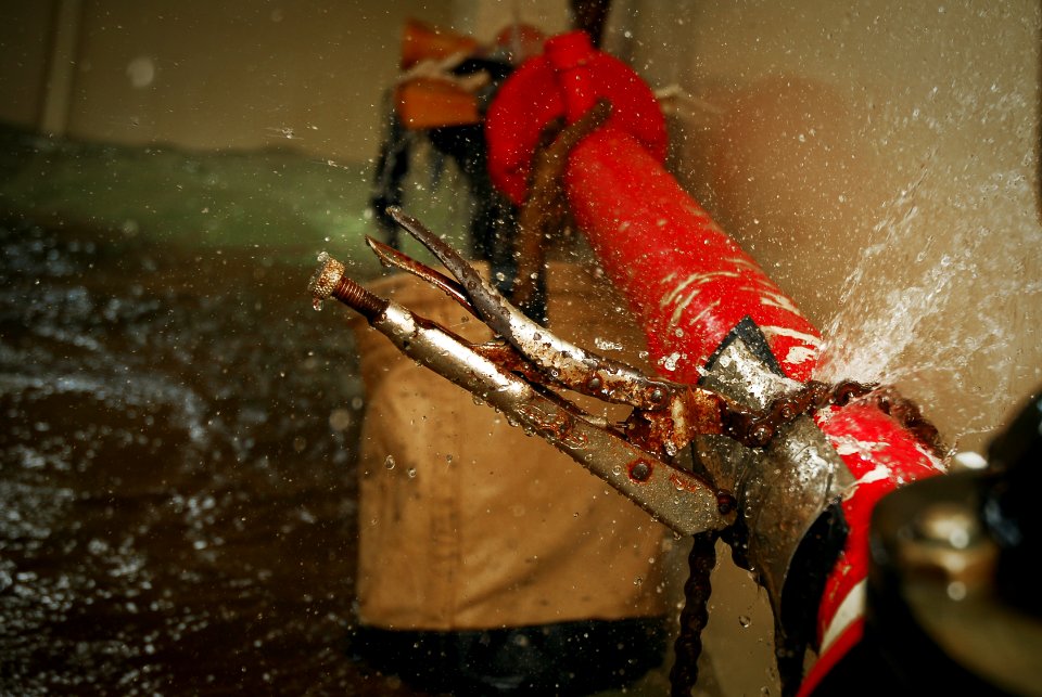 US Navy 090716-N-8590G-009 A chain wrench clamps a pipe patch to prevent further flooding of a space during the Damage Control Olympics at Mayport Naval Base