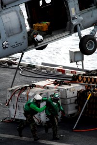US Navy 090716-N-9132C-069 An aircrewman looks down from an MH-60S Sea Hawk helicopter