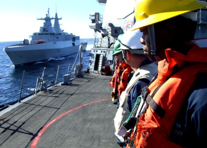 US Navy 090717-N-1655H-228 Boatswain's Mate 2nd Class Ronnie Graham stands by as the South African Navy frigate SAS Amatola (F 145) comes alongside the guided-missile destroyer USS Arleigh Burke (DDG 51)