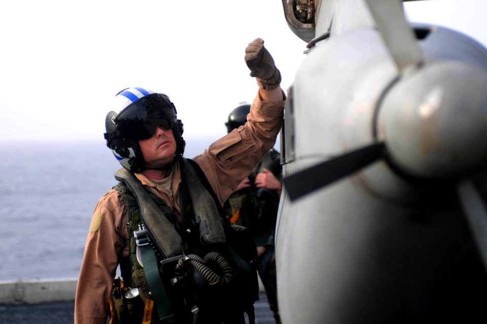 US Navy 090718-N-3610L-263 Lt. Cmdr. James Carver inspects the exterior of an EA-6B Prowler assigned to the Cougars of Tactical Electronic Warfare Squadron (VAQ) 139 before flight operations aboard the aircraft carrier USS Rona