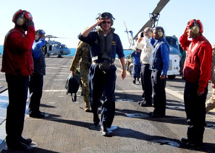 US Navy 090717-N-5538K-271 Rear Adm. Richard B. Landolt passes through rainbow sideboys on the flight deck of the amphibious transport dock ship USS Denver (LPD 9)