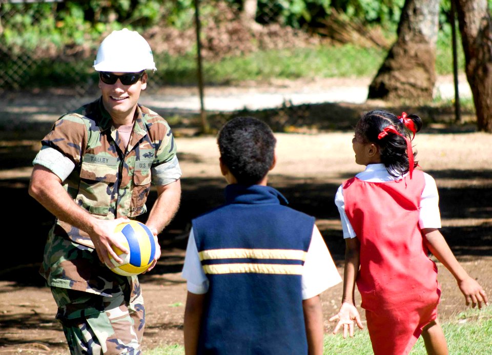 US Navy 090717-N-9689V-010 Lt.j.g. Shawn Talley, assigned to Amphibious Construction Battalion (ACB) 1, plays ball with local schoolchildren during a Pacific Partnership 2009 engineering civic action project