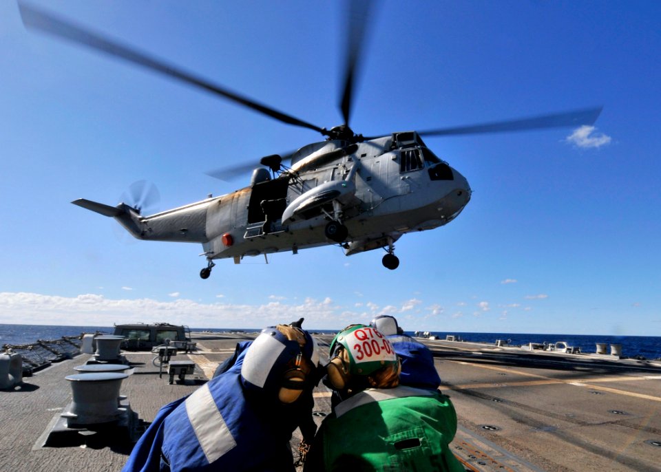 US Navy 090720-N-2638R-001 An SH-3 Sea King helicopter from Squadron 817 of the Royal Australian Navy prepares to land on Arleigh Burke-class guided-missile destroyer USS Mustin's (DDG 89) flight deck for a refueling
