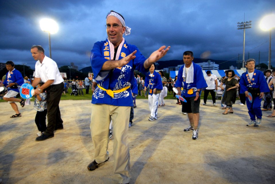 US Navy 090718-N-0807W-203 Capt. Francis X. Martin, commander, Fleet Activities Sasebo, participates in a traditional Japanese summer dance during a Bon Odori festival at Nimitz Park