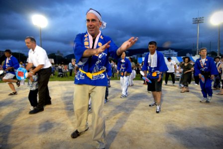 US Navy 090718-N-0807W-203 Capt. Francis X. Martin, commander, Fleet Activities Sasebo, participates in a traditional Japanese summer dance during a Bon Odori festival at Nimitz Park