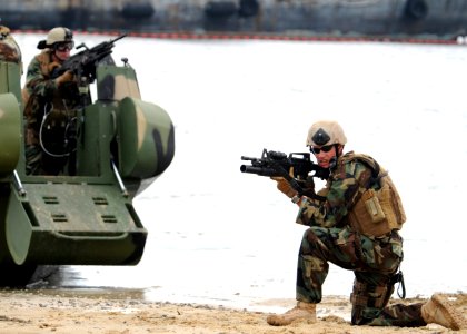 US Navy 090720-N-4267W-087 Engineman 2nd Class Robert Bender, assigned to the Riverine Squadron (RIVRON) 1 security team, provides security for the extraction of a suspected insurgent