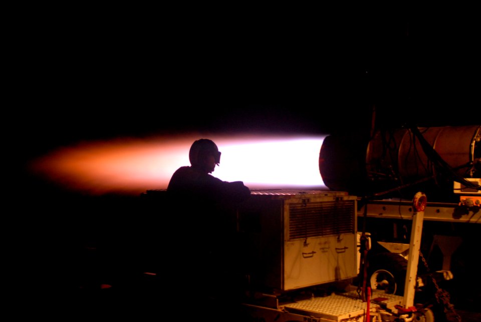 US Navy 090718-N-9132C-110 Aviation Machinist's Mate Airman Jesus Lopez watches the blast from a jet engine during an engine test cell run on the fantail of the aircraft carrier USS Ronald Reagan (CVN 76)