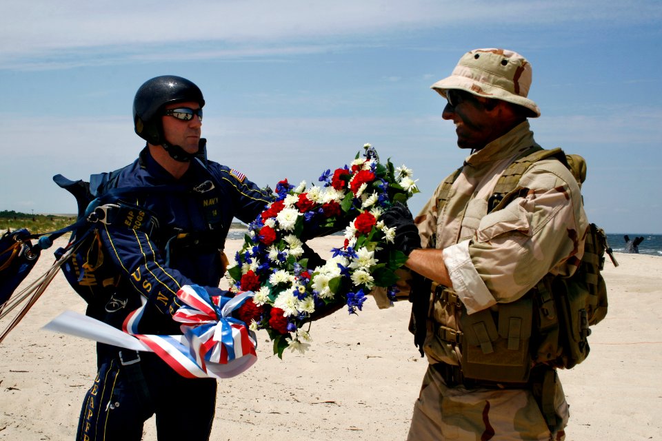 US Navy 090718-N-5366K-162 James Woods presents a wreath to a Navy SEAL from Naval Special Warfare Group (NSWG) 2 to honor fallen teammates