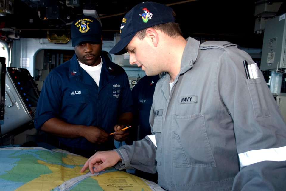 US Navy 090721-N-9123L-010 Quartermaster 1st Class Jory Mason of Chicago, Ill. and Royal Australian Navy Seaman Andrew Smith of guided-missile frigate HMAS Newcastle (FFG 06) review a chart aboard guided-missile destroyer USS M